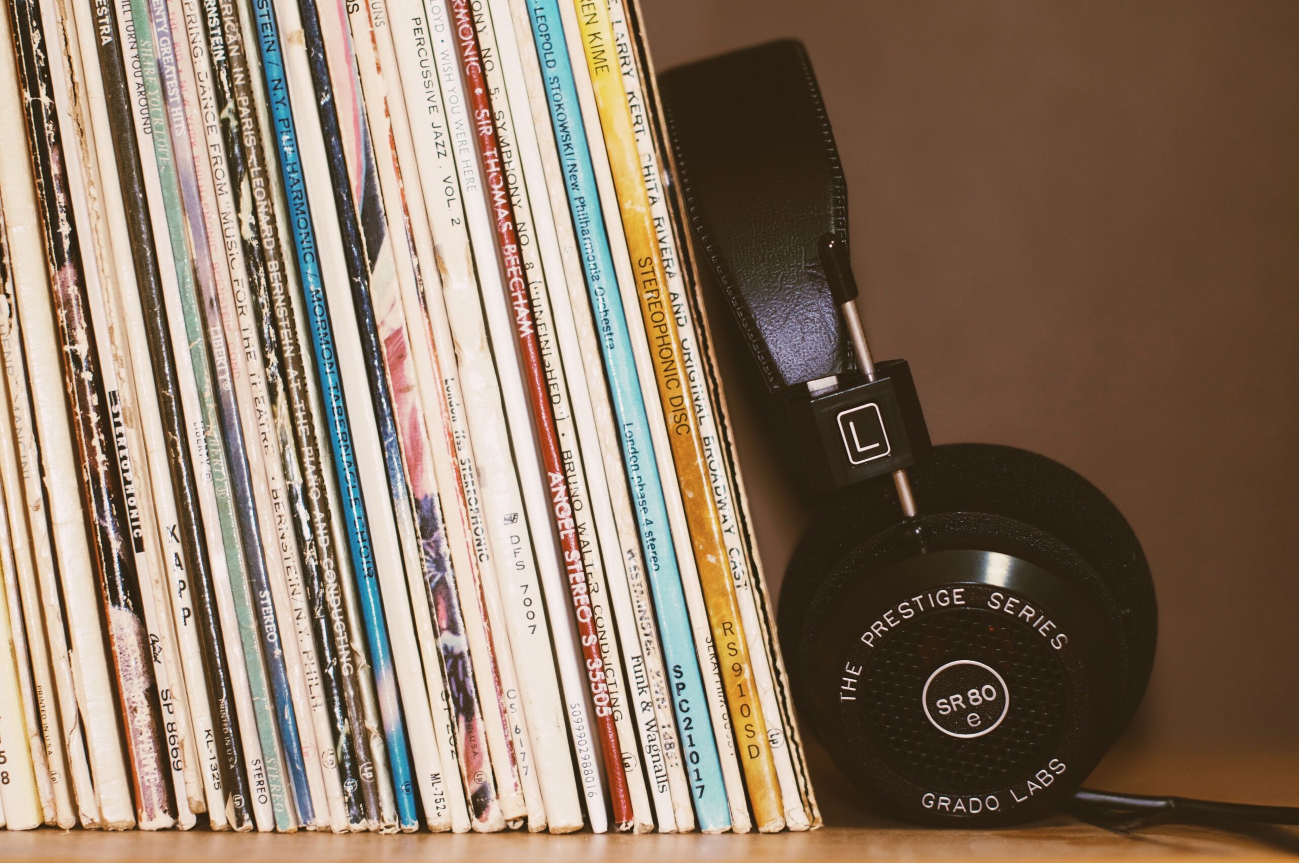 vinyl records and headphones on a shelf