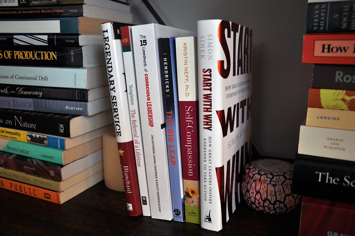 close up of six business books on a bookshelf