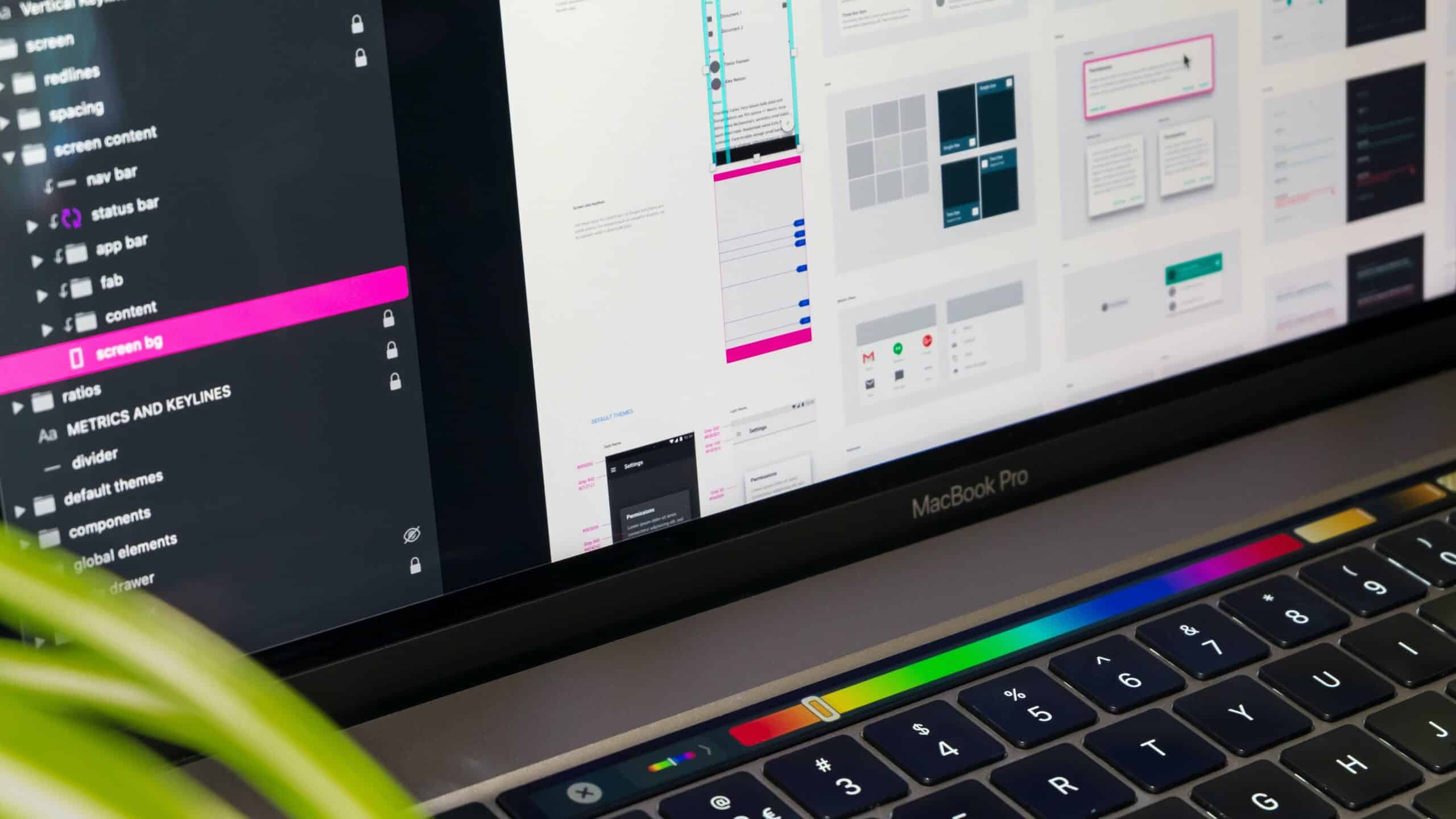 Macbook Pro screen that shows different elements and components of a website in a design platform.